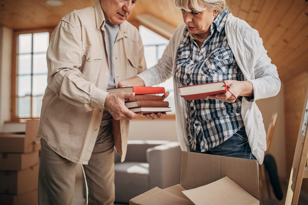 two senior citizens packing for a move